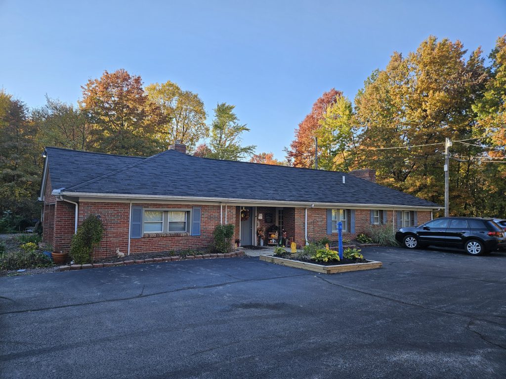 Amelia Grace Assisted Living facility in Mayfield, Ohio, featuring a welcoming brick exterior, well-maintained landscaping, and autumn foliage, showcasing a comfortable environment for seniors.